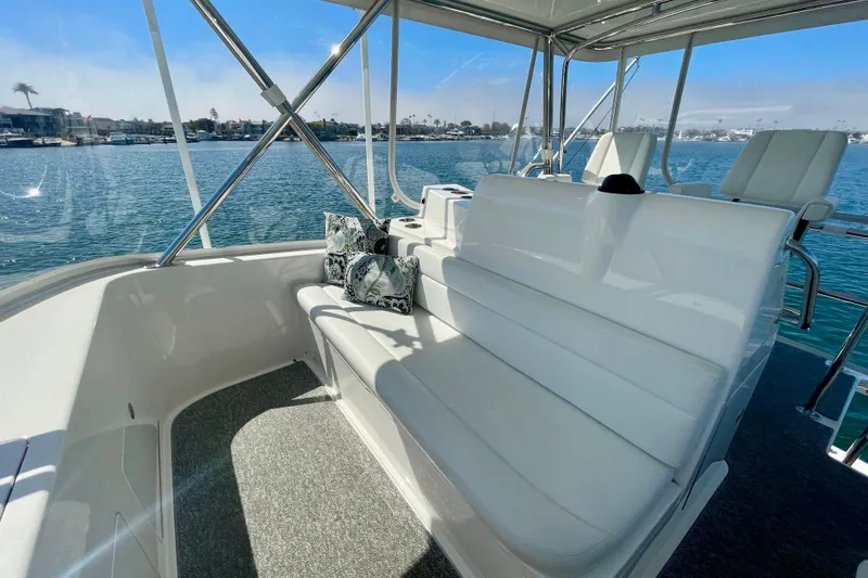 Slide: The Image of Luxurious 2006 Cabo 40 Flybridge yacht interior with comfortable seating and scenic water view. - 59
