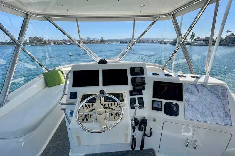 Slide: The Image of Helm of 2006 Cabo 40 Flybridge yacht with navigation equipment and scenic water view. - 65
