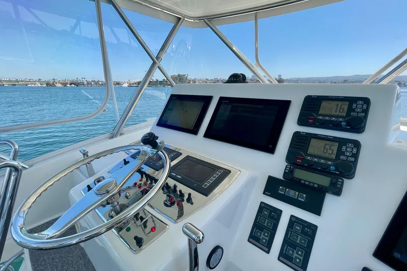 Slide: The Image of Helm of 2006 Cabo 40 Flybridge yacht with navigation instruments and steering wheel. - 67