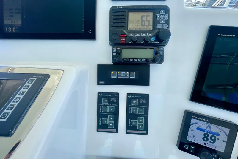 Slide: The Image of Control panel of a 2006 Cabo 40 Flybridge with navigation and communication equipment. - 69