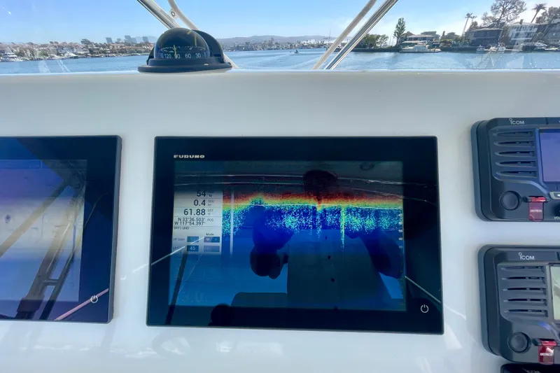 Slide: The Image of Cabo 40 Flybridge 2006 helm with Furuno display and navigation equipment, overlooking marina. - 70