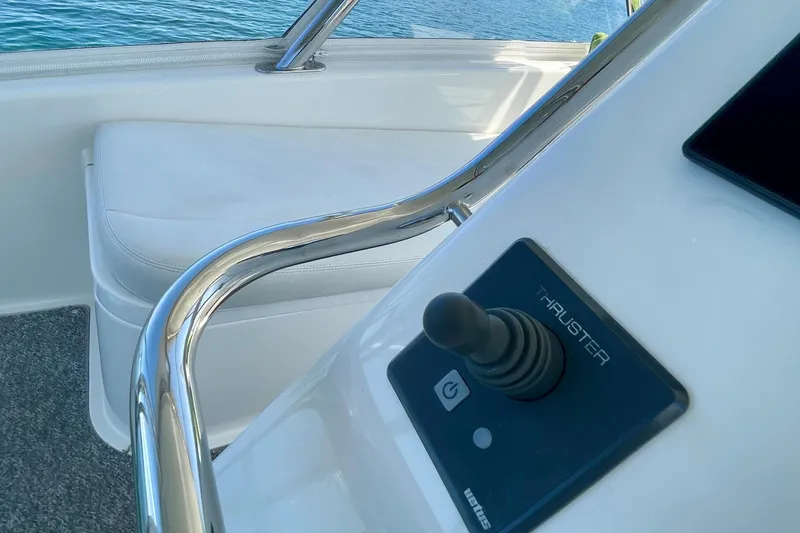 Slide: The Image of Control panel and seating on 2006 Cabo 40 Flybridge yacht, featuring a thruster joystick. - 73