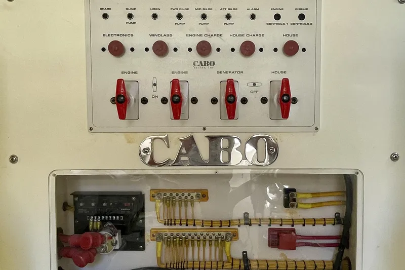 Slide: The Image of Electrical panel of a 2006 Cabo 40 Flybridge yacht with labeled switches and wiring. - 78