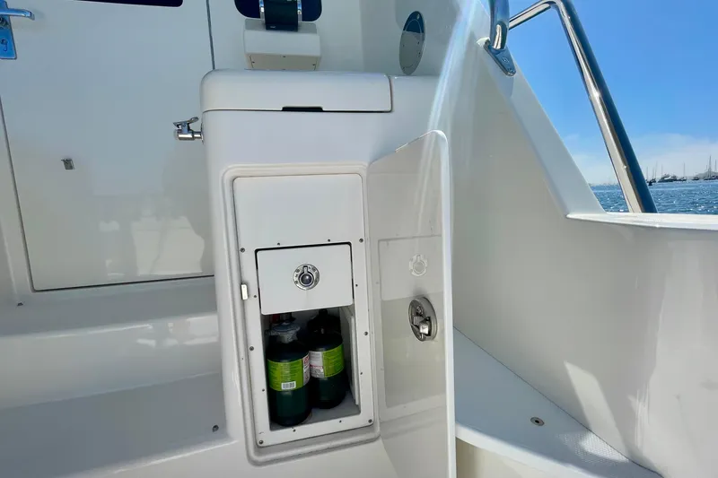 Slide: The Image of Storage compartment on 2006 Cabo 40 Flybridge boat, open to reveal propane tanks. - 80