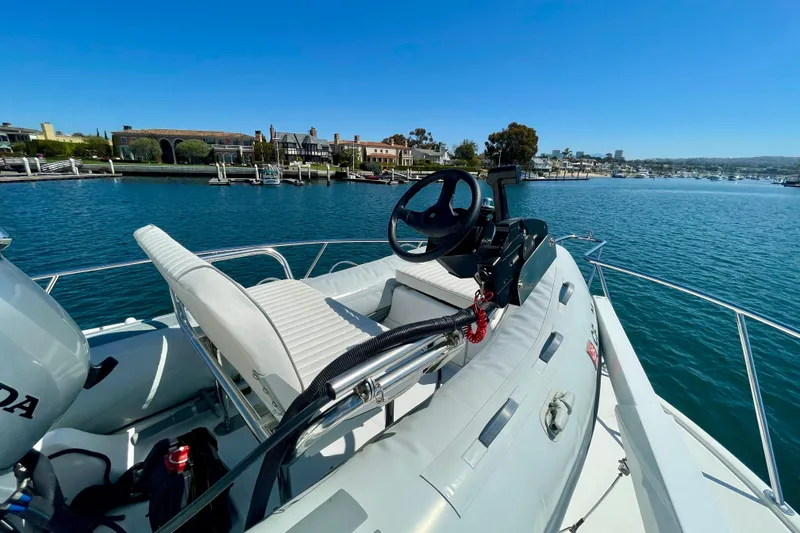 Slide: The Image of 2006 Cabo 40 Flybridge boat with steering wheel, docked in scenic marina. - 86