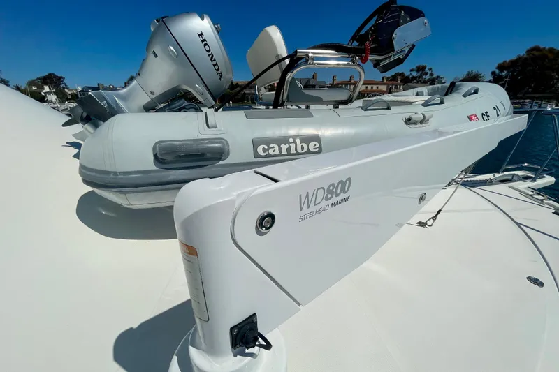 Slide: The Image of Inflatable boat with Honda motor on 2006 Cabo 40 Flybridge yacht deck. - 87