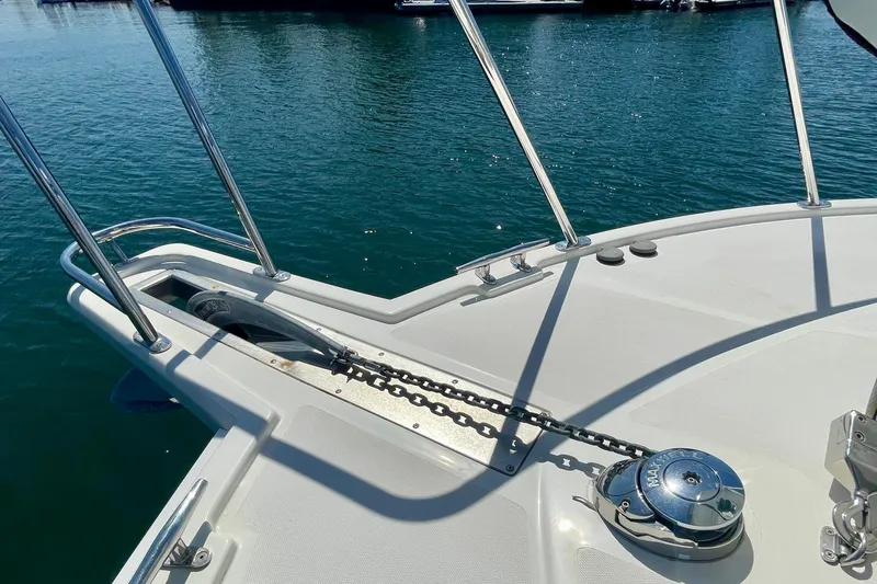 Slide: The Image of Bow of 2006 Cabo 40 Flybridge yacht with anchor chain and winch. - 90