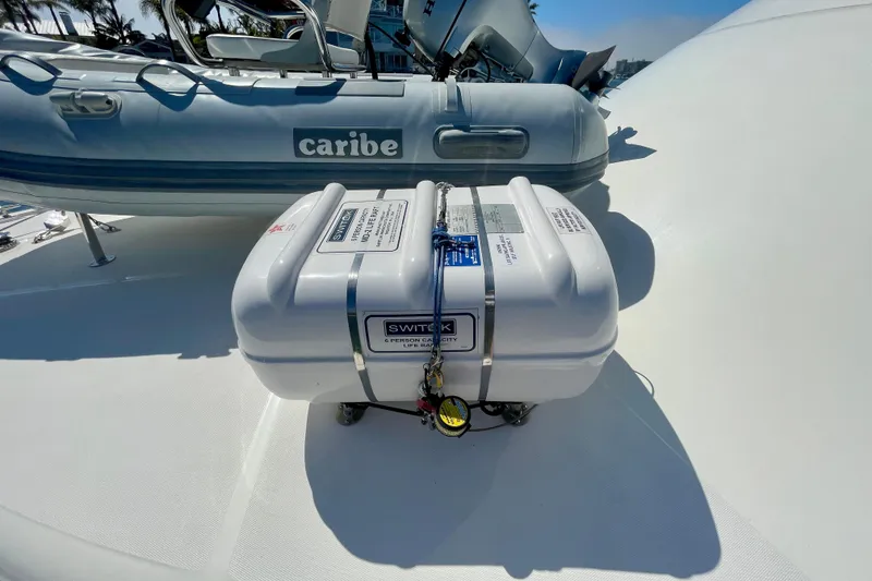 Slide: The Image of Life raft on 2006 Cabo 40 Flybridge yacht deck, with Caribe inflatable boat in background. - 91