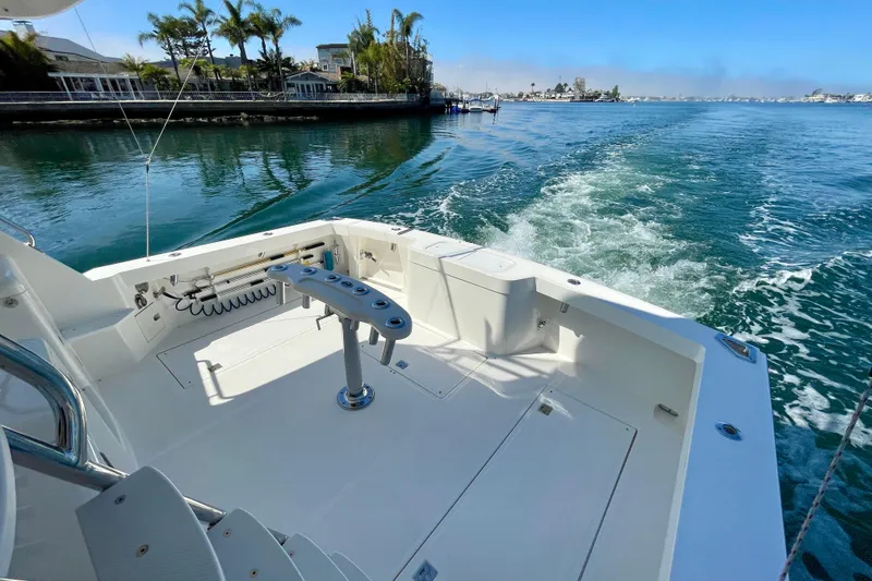 Slide: The Image of 2006 Cabo 40 Flybridge boat cruising on a sunny day, featuring spacious deck and scenic waterway. - 93