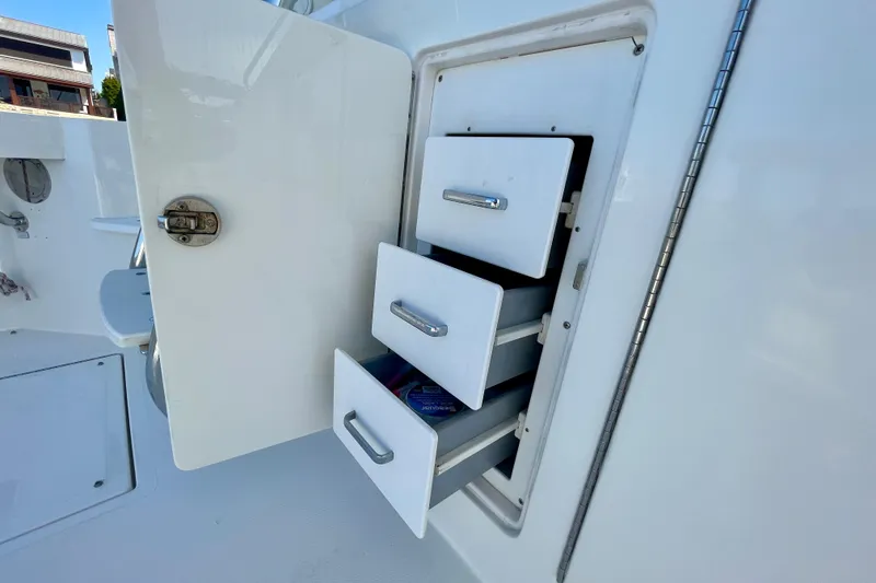 Slide: The Image of Open storage drawers on a 2006 Cabo 40 Flybridge boat. - 99