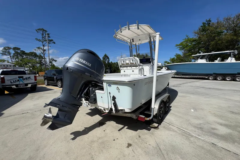 Slide: The Image of 2015 Sportsman Masters 227 Bay Boat with Yamaha engine on trailer in sunny parking lot. - 13