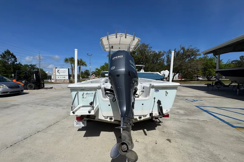 Slide: The Image of 2015 Sportsman Masters 227 Bay Boat with outboard motor in a parking lot. - 15