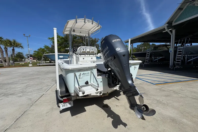 Slide: The Image of 2015 Sportsman Masters 227 Bay Boat with Yamaha 200 engine, parked outdoors. - 16