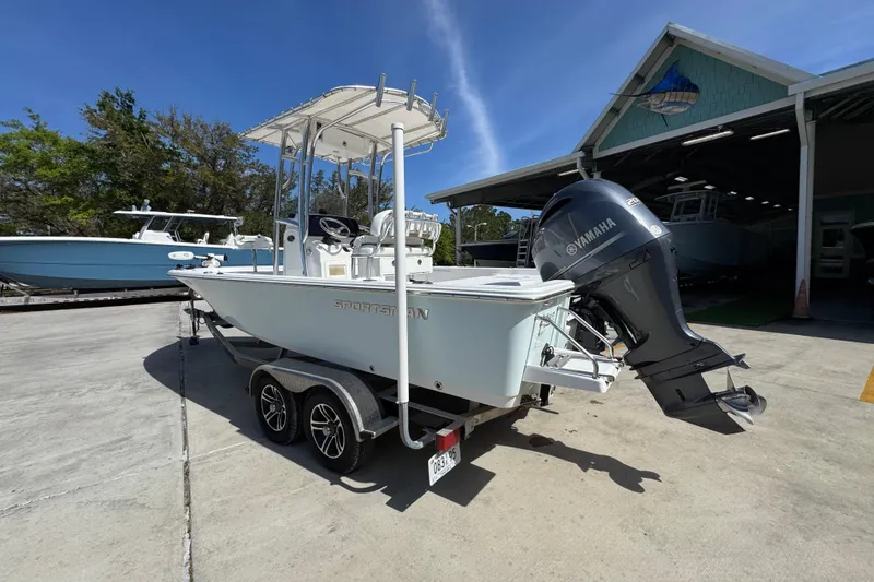 Slide: The Image of 2015 Sportsman Masters 227 Bay Boat with Yamaha engine on trailer, parked outdoors. - 17