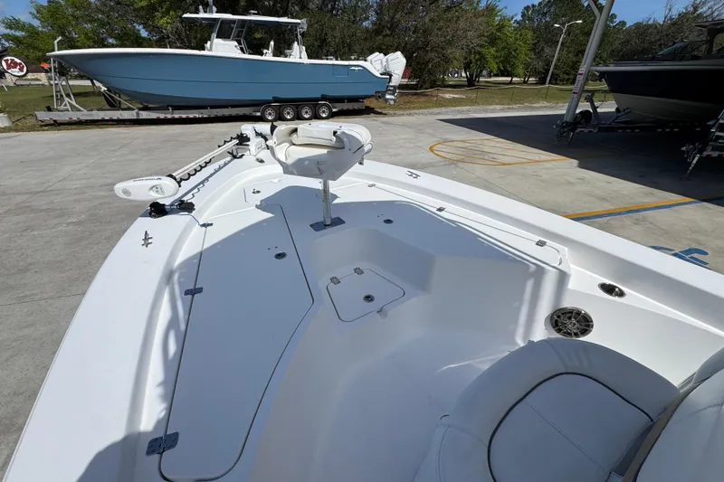 Slide: The Image of 2015 Sportsman Masters 227 Bay Boat with trolling motor, parked on concrete lot. - 20