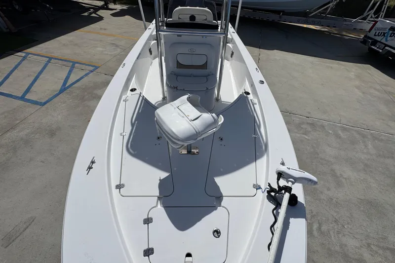 Slide: The Image of 2015 Sportsman Masters 227 Bay Boat on concrete, featuring a trolling motor and spacious deck. - 23