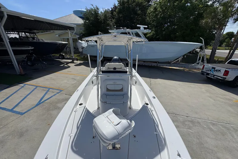 Slide: The Image of 2015 Sportsman Masters 227 Bay Boat parked at a marina under clear skies. - 24