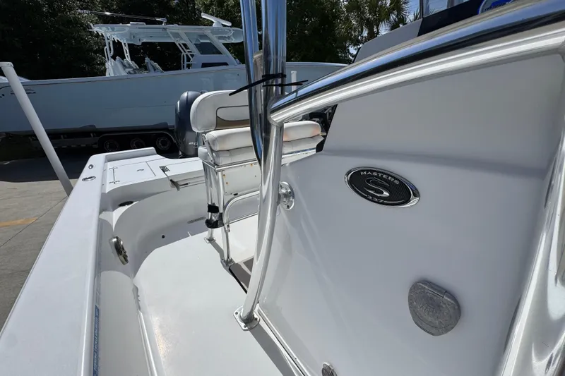 Slide: The Image of 2015 Sportsman Masters 227 Bay Boat interior with seating and emblem detail. - 27