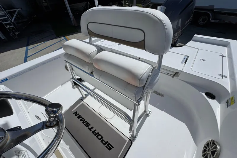 Slide: The Image of 2015 Sportsman Masters 227 Bay Boat interior with steering wheel and cushioned seating. - 28