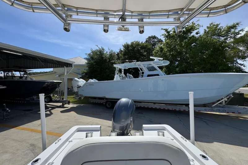 Slide: The Image of 2015 Sportsman Masters 227 Bay Boat on trailer, parked outdoors under clear sky. - 30