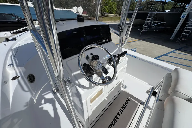 Slide: The Image of 2015 Sportsman Masters 227 Bay Boat cockpit with steering wheel and controls. - 32