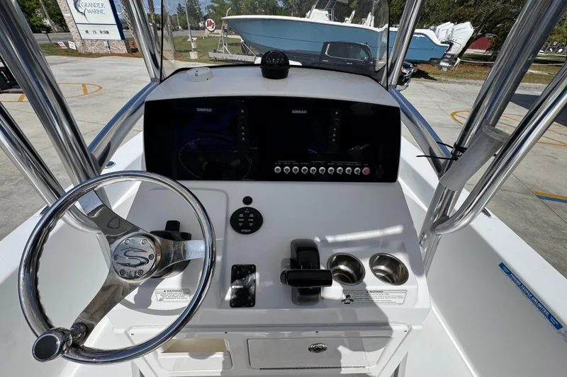 Slide: The Image of 2015 Sportsman Masters 227 Bay Boat dashboard with steering wheel and controls. - 33