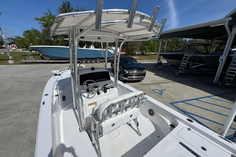 Slide: The Image of 2015 Sportsman Masters 227 Bay Boat with T-top and console, parked in a marina. - 36