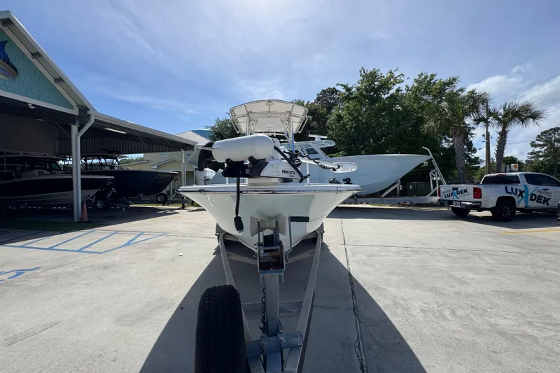 Slide: The Image of 2015 Sportsman Masters 227 Bay Boat on trailer at dealership, sunny day. - 6