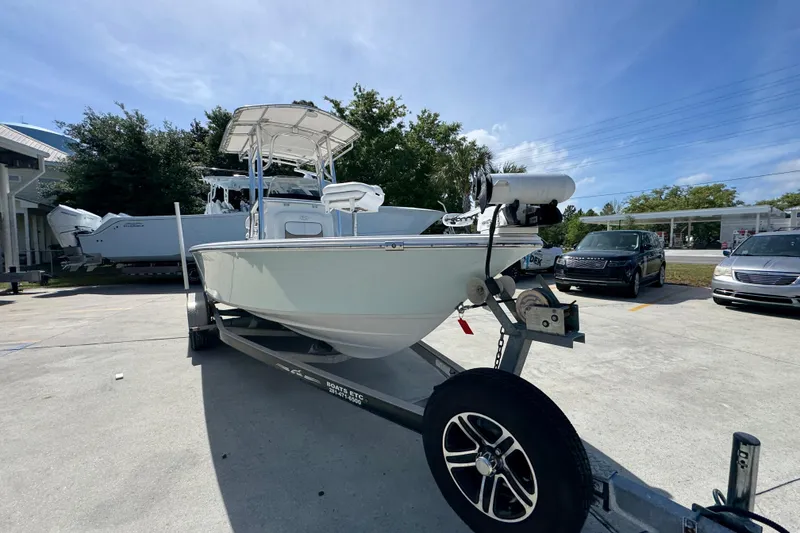 Slide: The Image of 2015 Sportsman Masters 227 Bay Boat on trailer in parking lot under clear sky. - 7