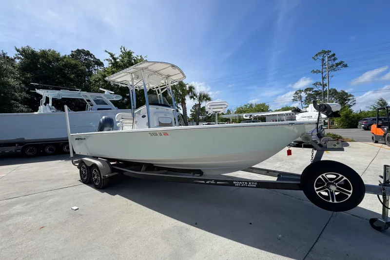 Slide: The Image of 2015 Sportsman Masters 227 Bay Boat on trailer, parked outdoors under clear sky. - 8