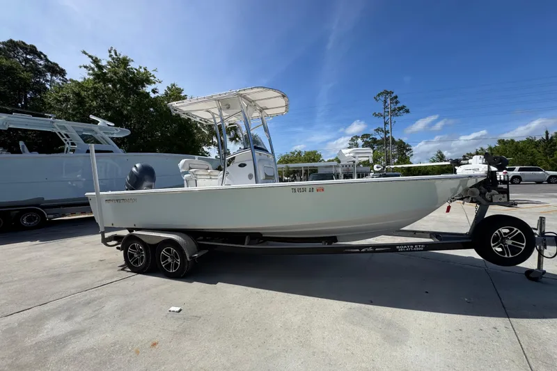 Slide: The Image of 2015 Sportsman Masters 227 Bay Boat on trailer, parked outdoors under clear sky. - 9