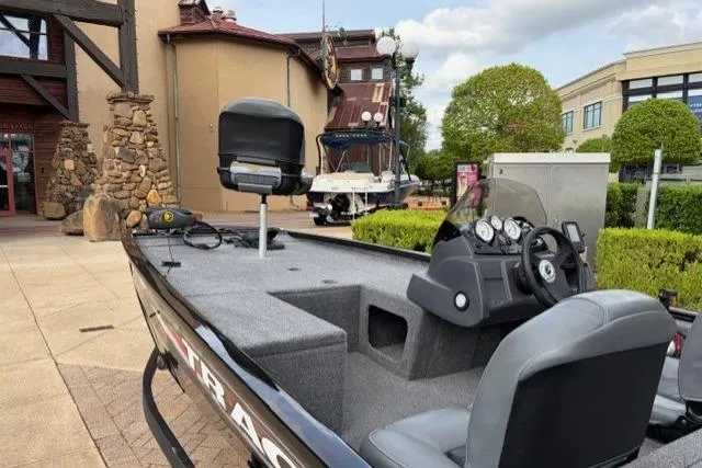 Slide: The Image of 2025 Tracker Pro 170 boat displayed outdoors, featuring sleek design and modern dashboard. - 13