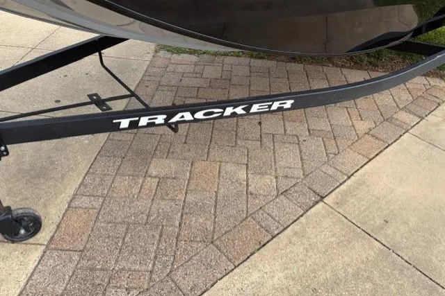 Slide: The Image of 2025 Tracker Pro 170 boat trailer on paved surface. - 14
