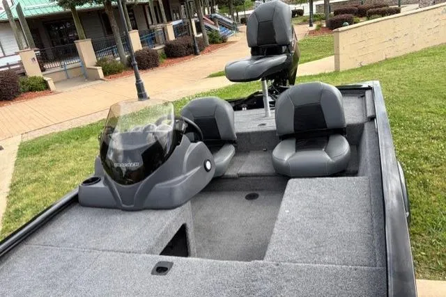 Slide: The Image of 2025 Tracker Pro 170 boat with gray seating and console, parked on grass. - 15