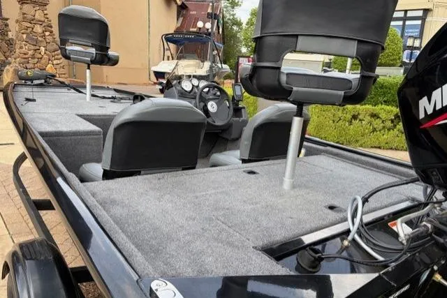 Slide: The Image of 2025 Tracker Pro 170 boat interior with seating and steering console. - 2