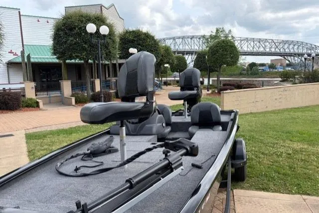 Slide: The Image of 2025 Tracker Pro 170 boat parked near a bridge and buildings. - 3