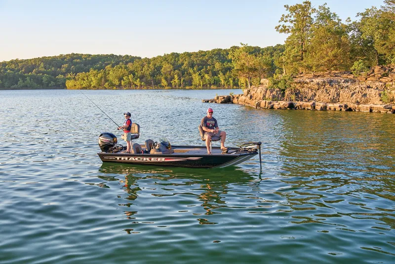 Slide: The Image of Two anglers on a 2025 Tracker Pro 170 boat on a serene lake. - 42