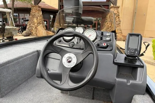 Slide: The Image of 2025 Tracker Pro 170 boat dashboard with steering wheel and navigation system. - 7