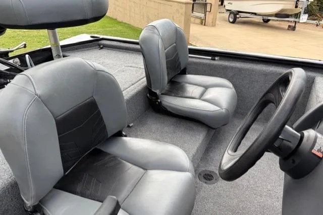 Slide: The Image of Interior of 2025 Tracker Pro 170 boat with gray seating and steering wheel. - 9