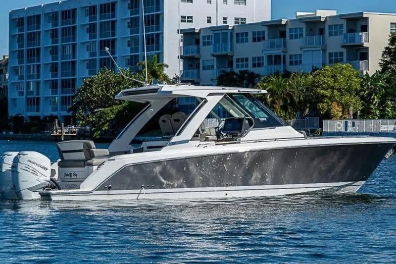 The Image of 2023 Tiara Sport 34 LS boat on water near buildings. - 0