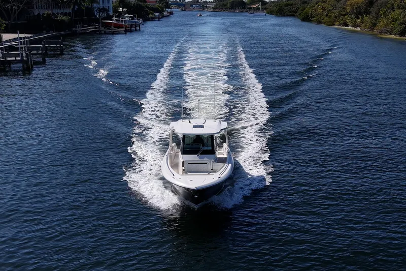 Slide: The Image of 2023 Tiara Sport 34 LS cruising on a scenic waterway. - 10