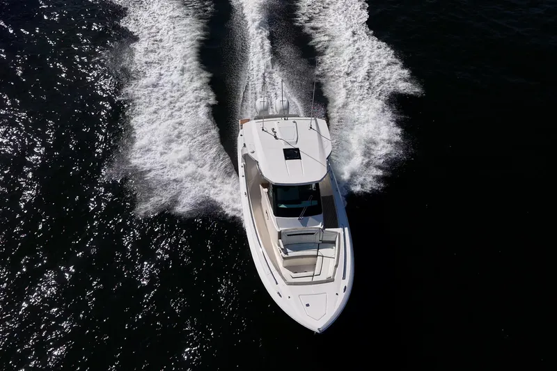Slide: The Image of 2023 Tiara Sport 34 LS boat cruising on open water, aerial view. - 16