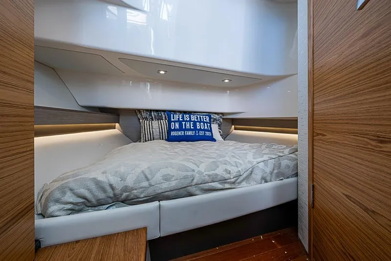 Slide: The Image of 2023 Tiara Sport 34 LS cabin interior with cozy bed and decorative pillow. - 19