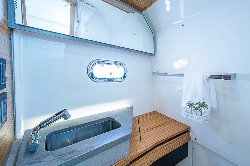 Slide: The Image of Luxurious 2023 Tiara Sport 34 LS yacht bathroom with modern sink and towel rack. - 21