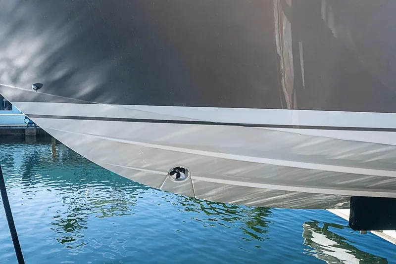 Slide: The Image of 2023 Tiara Sport 34 LS boat hull reflecting on calm water. - 23