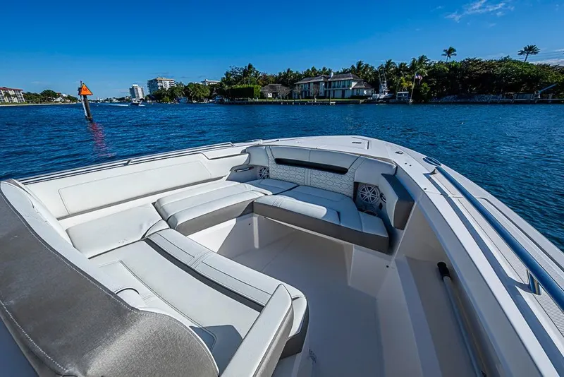 Slide: The Image of 2023 Tiara Sport 34 LS boat interior with luxurious seating on a sunny day. - 27