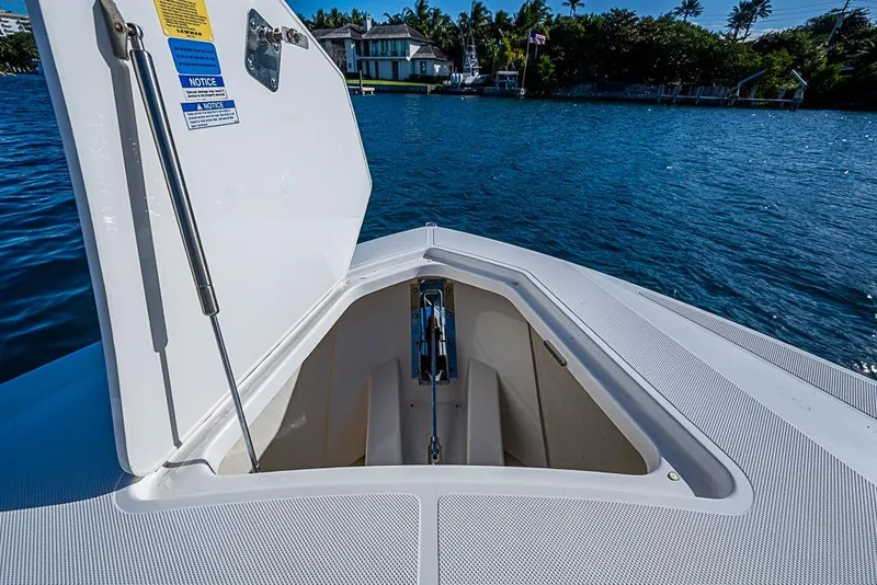 Slide: The Image of Open hatch on 2023 Tiara Sport 34 LS boat, overlooking serene waterfront view. - 28