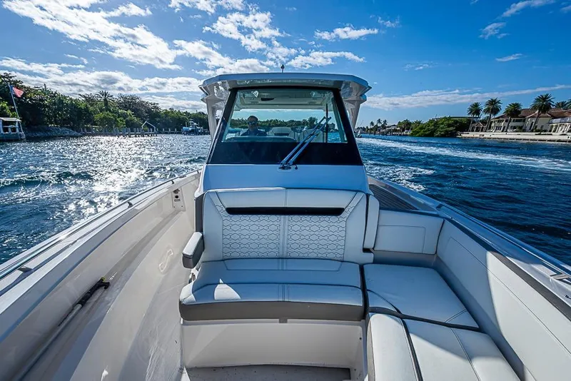 Slide: The Image of 2023 Tiara Sport 34 LS boat cruising on a sunny day with scenic waterfront views. - 29