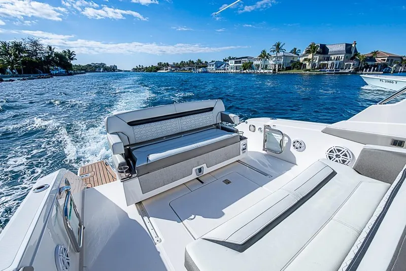 Slide: The Image of 2023 Tiara Sport 34 LS boat cruising on a sunny day, featuring luxurious seating. - 30