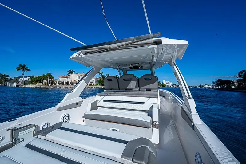 Slide: The Image of 2023 Tiara Sport 34 LS luxury boat cruising on a sunny day. - 36